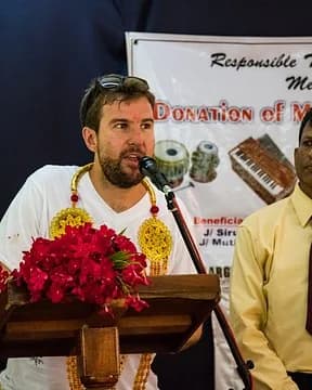 Julian speaking at a community event.