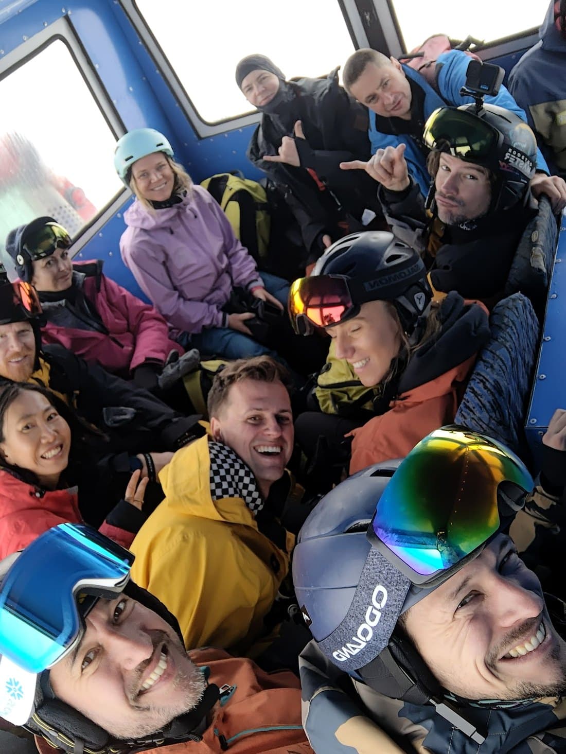 The group packed into the back of the snowcat in helmets and goggles, laughing, on the way up.