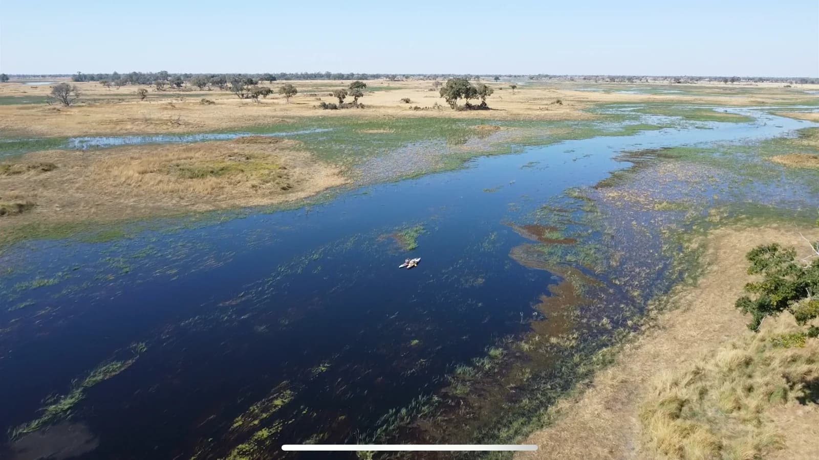 Aerial view of blue Delta channels and grassy islands in the Okavango.